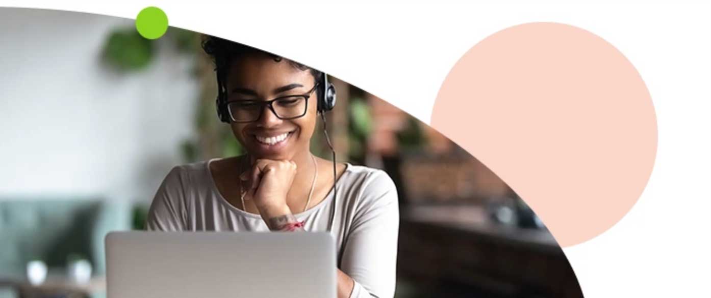 Woman smiling while looking at laptop