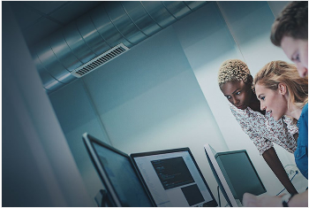 3 co-workers looking at a computer