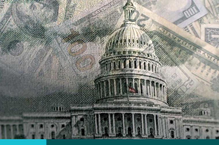 Multiple pieces of paper currency superimposed over the Capitol Building