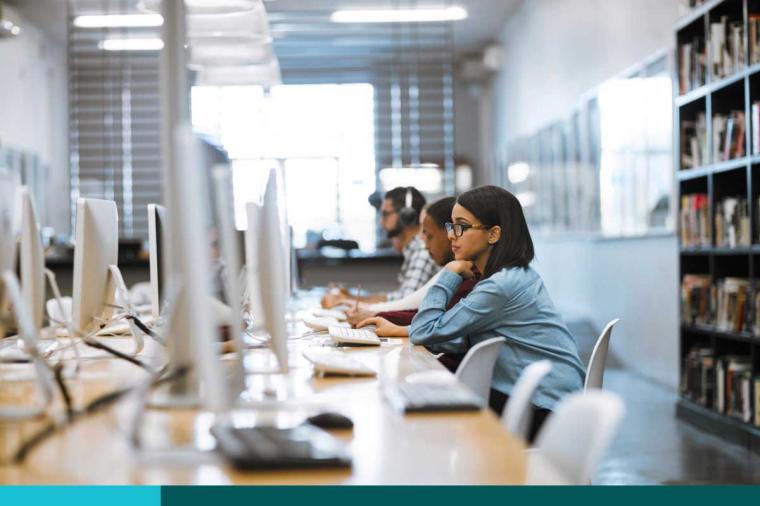 Shot of a group of university students working on computers in the library at campus