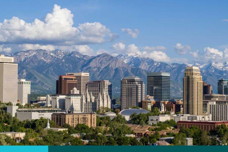 With the Wasatch Mountains in the background, clouds roll past downtown skyscrapers of Salt Lake City in Utah.