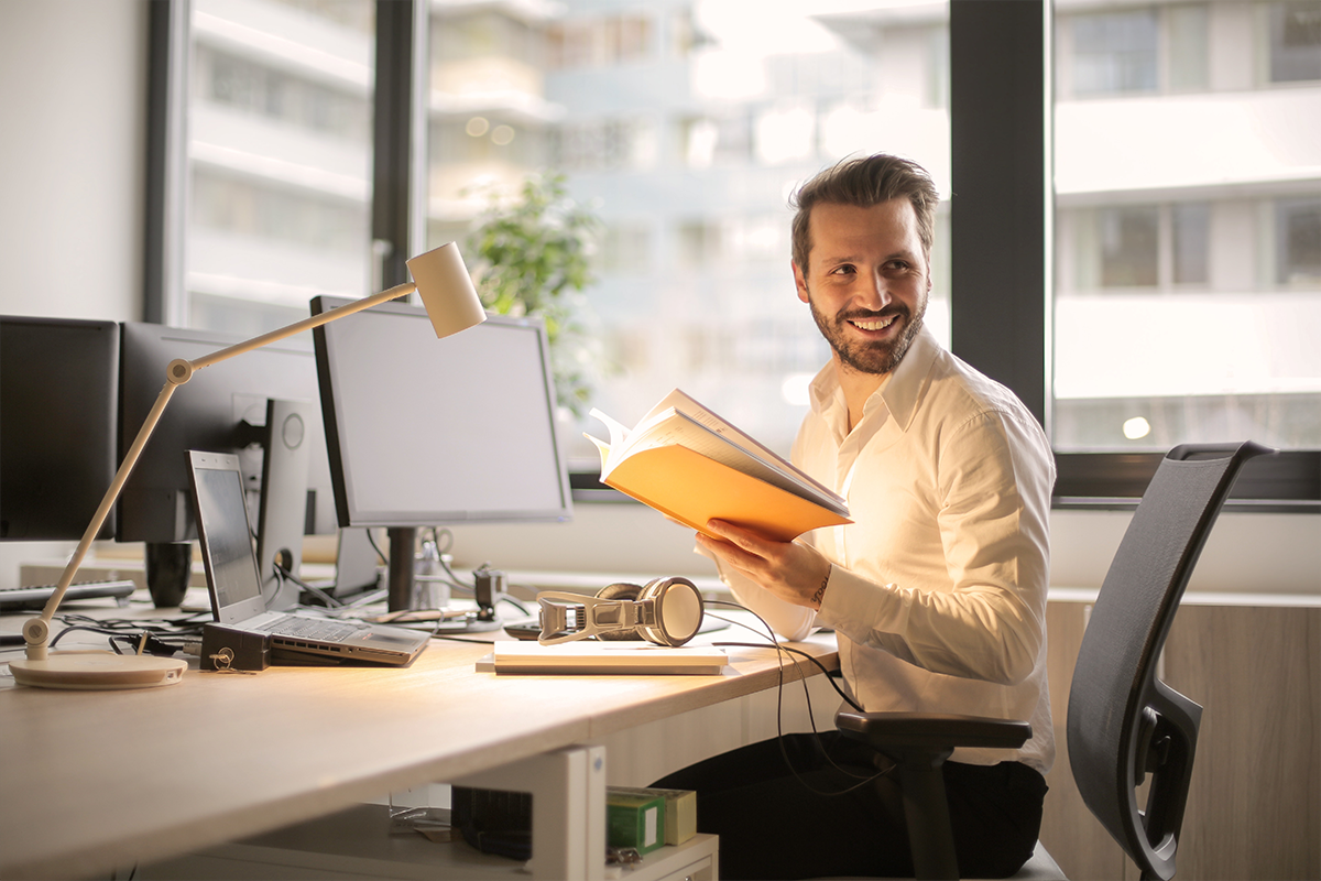 Smiling man sitting at his work desk