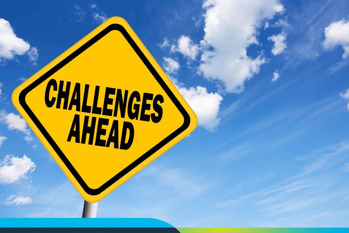 Yellow road sign. text reads: Challenges ahead