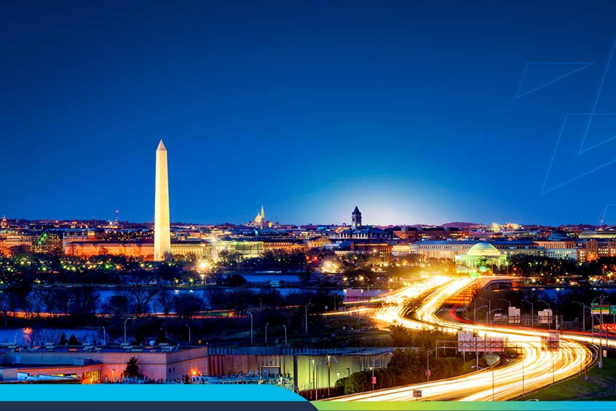 Time-lapse image of DC traffic at night with the Washington Monument in the background
