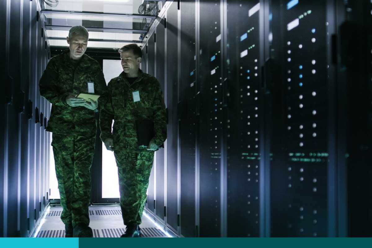 2 Navy men walking in a server room