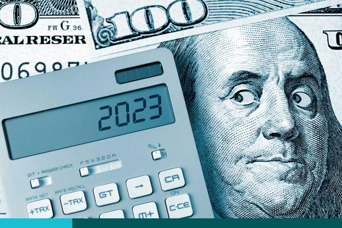 Benjamin Franklin looking sideways at a calculator displaying 2023