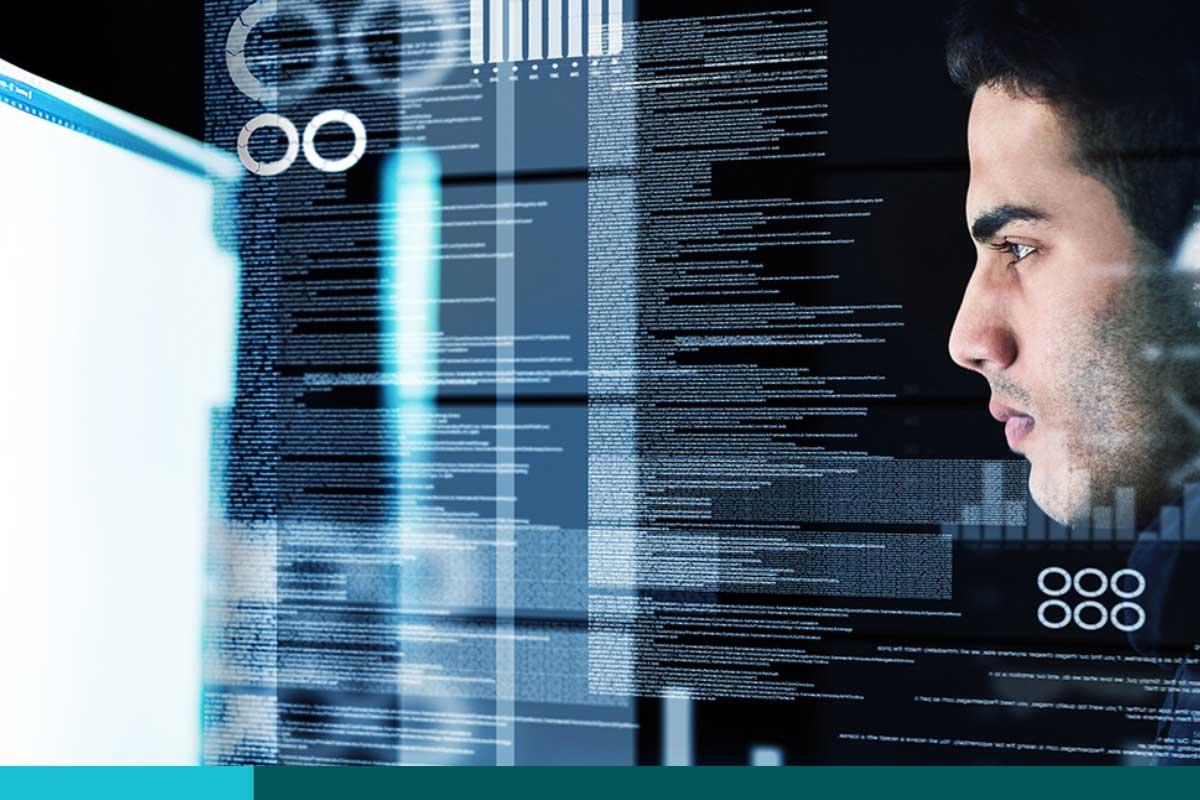 Man staring intently at a computer screen with lines of code jumping off it