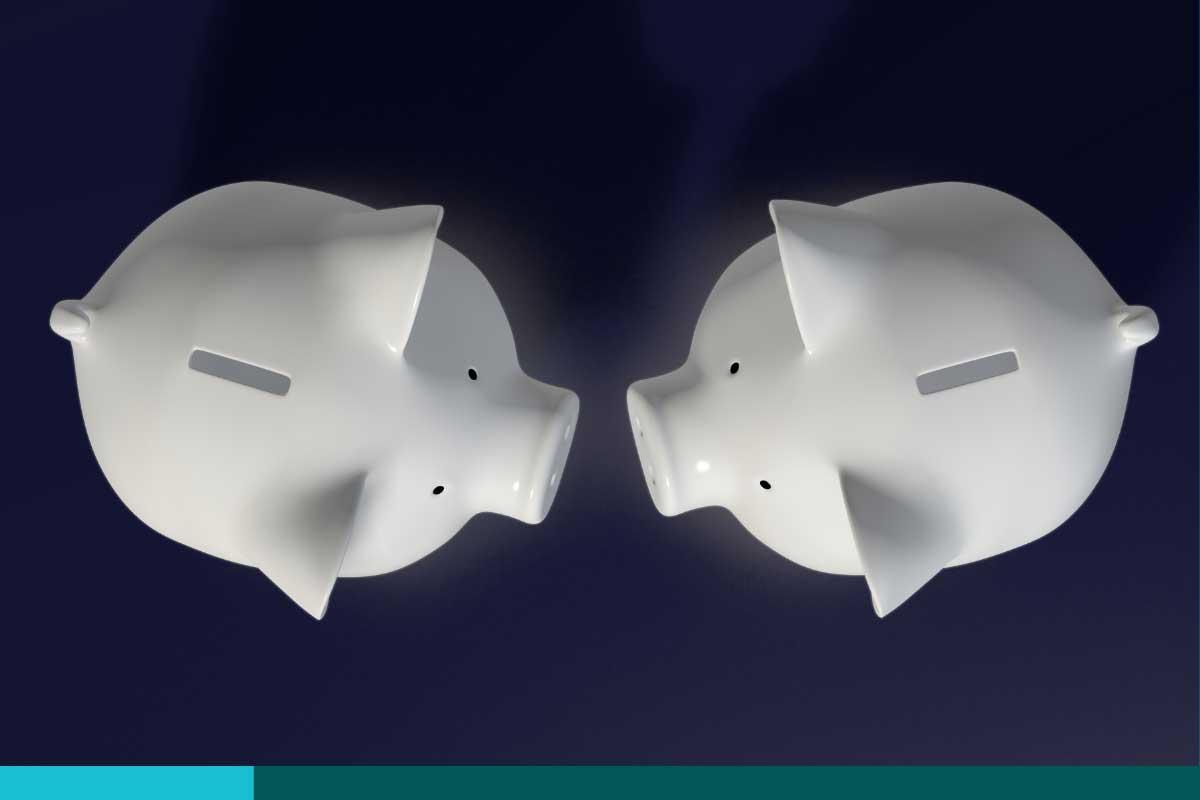 Overhead view of two white piggy banks facing each other